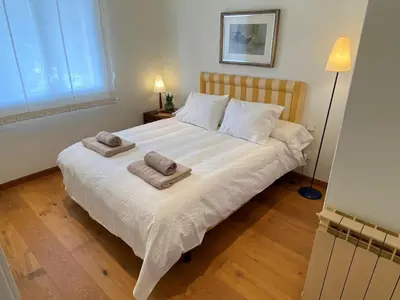 a bedroom with a large white bed with towels on it at Apart Villa Cristina 5 min walk to the beach RoofTop Duplex 180 M2 Very Cared in Sitges