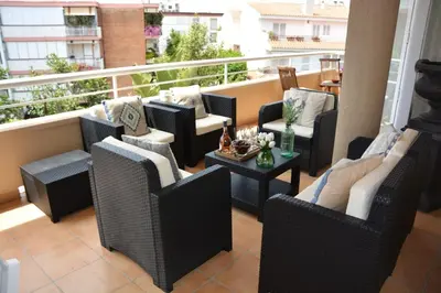 a balcony with chairs and tables on a balcony at Apart Villa Cristina 5 min walk to the beach RoofTop Duplex 180 M2 Very Cared in Sitges