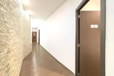 a hallway with a brick wall and a door at Laramond Barcelona Rooms in Barcelona