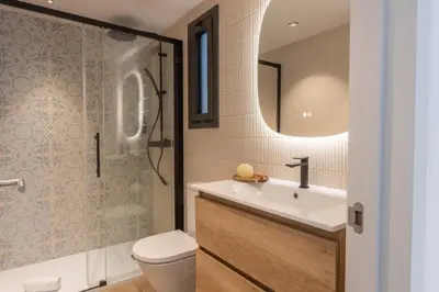 a bathroom with a toilet and a sink and a shower at Lodging Apartments Besos River 11 in Santa Coloma