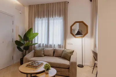 a living room with a couch and a table at Lodging Apartments Besos River B1 in Santa Coloma