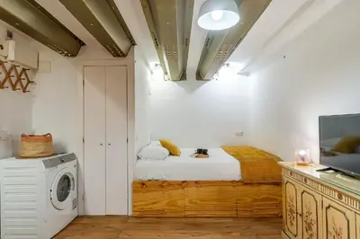 a bedroom with a bed and a washing machine at 2537 - AB Sant Antoni Studio in Barcelona