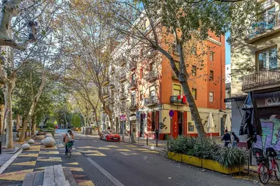 a large building on a city street with people walking at 2537 - AB Sant Antoni Studio in Barcelona