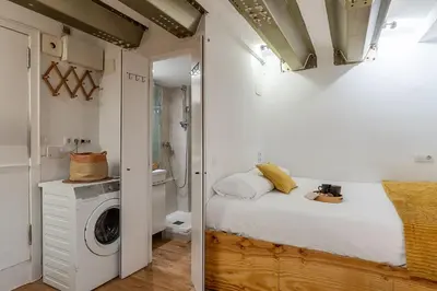 a bedroom with a bed and a washing machine at 2537 - AB Sant Antoni Studio in Barcelona