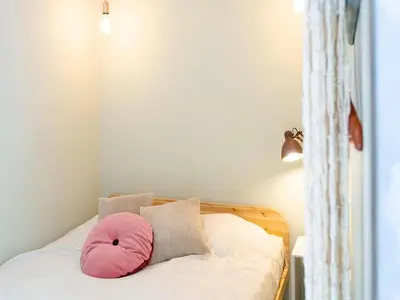 a pink pillow sitting on top of a bed at Designer villa with sauna and swimming pool in Canyelles