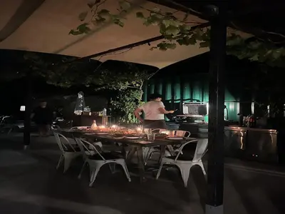 a man standing in a kitchen with a table at Designer villa with sauna and swimming pool in Canyelles