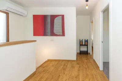 a hallway of a house with white walls and wooden floors at Casa con encanto a los pies del Montseny in La Batlloria