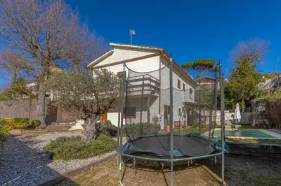 a house with a trampoline in the yard at Casa con encanto a los pies del Montseny in La Batlloria