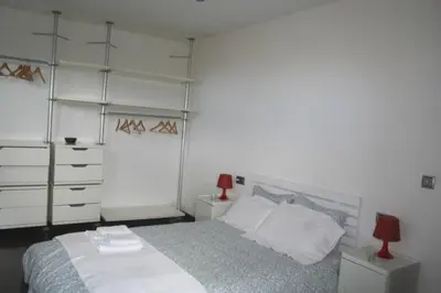 a bedroom with a bed and a red lamp at Casa ceca de la Playa y Barcelona, con piscina climatizada y jacuzzi in Vallromanas