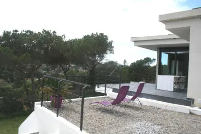 two purple chairs sitting on a porch of a house at Casa ceca de la Playa y Barcelona, con piscina climatizada y jacuzzi in Vallromanas