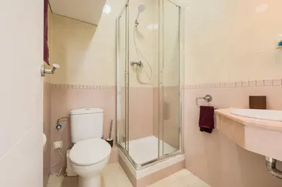 a bathroom with a shower and a toilet and a sink at Habitación 5 con baño junto al Palau Güell in Barcelona