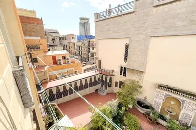 an apartment balcony with a view of a city at Habitación 5 con baño junto al Palau Güell in Barcelona