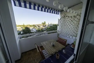 a balcony with a table and chairs and a window at HomeHolidaysRentals Pinedalovers - Costa Barcelona in Pineda de Mar