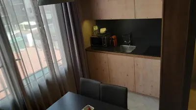 a small kitchen with a table and a microwave at Casa Abamita in Barcelona