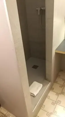 a bathroom with a shower with a white towel at Casa Abamita in Barcelona