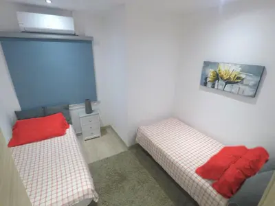 a room with two beds and a painting on the wall at YOUR HOME - Sagrada Familia Apartment in Barcelona