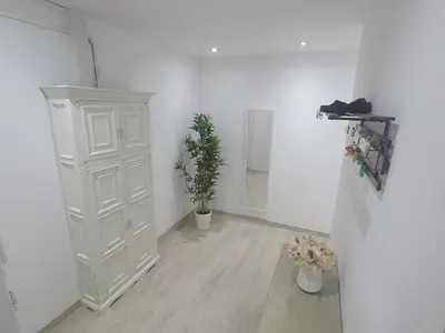a white room with a white cabinet and a plant at YOUR HOME - Sagrada Familia Apartment in Barcelona