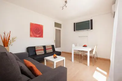 a living room with a couch and a table at YOUR HOME - Sagrada Familia Apartment in Barcelona