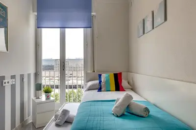 a bedroom with a bed with a large window at 4 Bedroom High-Rise Apartment Amazing views! in Barcelona