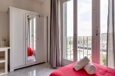 a bedroom with a bed and a large window at 4 Bedroom High-Rise Apartment Amazing views! in Barcelona