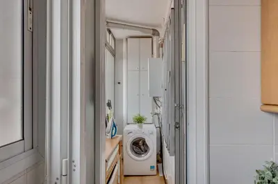 a laundry room with a washing machine in a hallway at 4 Bedroom High-Rise Apartment Amazing views! in Barcelona
