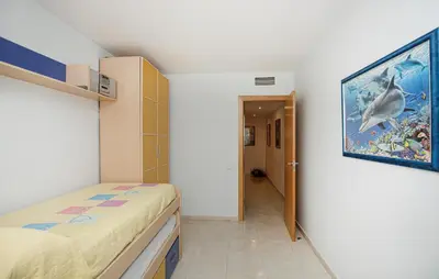 a bedroom with a bed and a painting on the wall at Beautiful Apartment In Pineda De Mar in Pineda de Mar