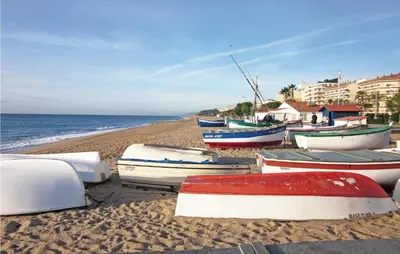 a group of boats sitting on the beach at Beautiful Apartment In Pineda De Mar in Pineda de Mar