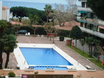 a large swimming pool next to a building at Apartment Llavaneres II in Sant Andreu de Llavaneres