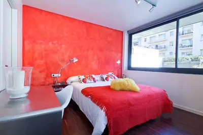 a red bedroom with a bed and a red wall at My Space Barcelona Private Pool Garden in Barcelona
