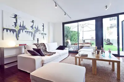a living room with a white couch and a table at My Space Barcelona Private Pool Garden in Barcelona