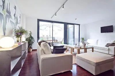 a living room with a couch and a table at My Space Barcelona Private Pool Garden in Barcelona