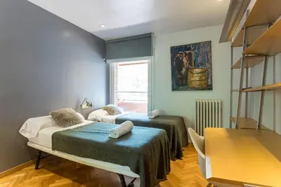 a room with two beds and a table in it at My Space Barcelona Bonanova Center in Barcelona