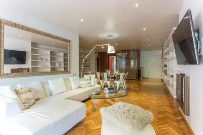 a living room with a white couch and a tv at My Space Barcelona Bonanova Center in Barcelona
