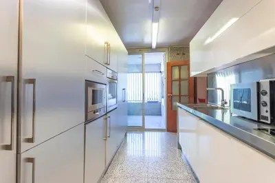 a kitchen with white cabinets and stainless steel appliances at My Space Barcelona Bonanova Center in Barcelona