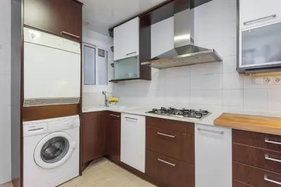 a kitchen with a washing machine and a washer at Flateli Aribau in Barcelona