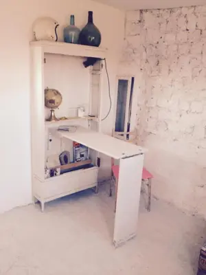 a white cabinet with vases on top of it at Apartments San Ignacio de Loyola in Manresa
