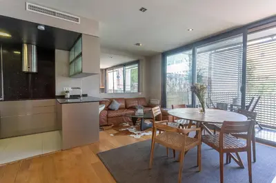 a kitchen and living room with a table and chairs at My Space Barcelona Gracia Pool Terrace in Barcelona