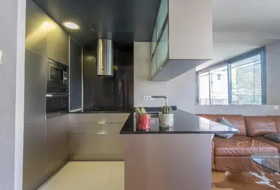 a kitchen with a counter and a couch in a room at My Space Barcelona Gracia Pool Terrace in Barcelona