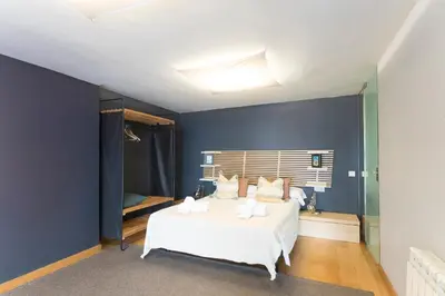 a bedroom with blue walls and a bed with pillows at My Space Barcelona Gracia Pool Terrace in Barcelona