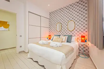 a bedroom with a large bed with two towels on it at Sweett - Sants in Barcelona
