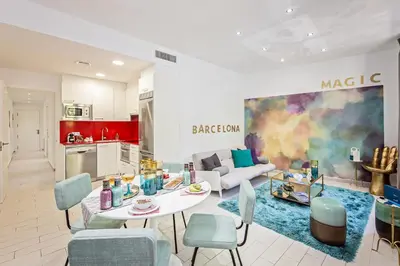 a kitchen and a living room with a table and chairs at Sweett - Sants in Barcelona