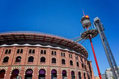 a building with a ferris wheel on top of it at Sweett - Sants in Barcelona