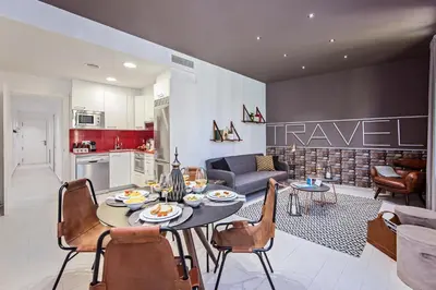 a kitchen and living room with a table and chairs at Sweett - Sants in Barcelona