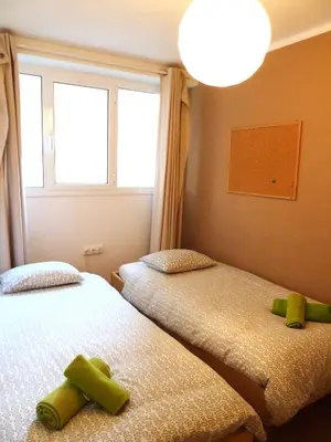 a bedroom with two beds with green stuffed animals on them at Joanic Apartment Escorial in Barcelona