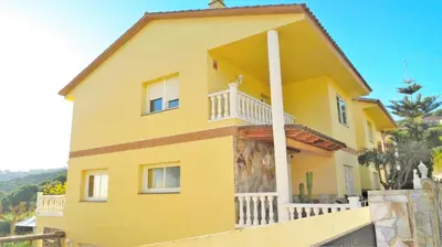 a yellow house with a white balcony at Villa Carolina in Mataró