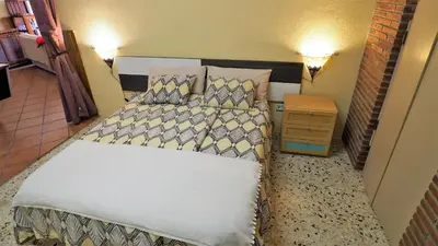 a small bedroom with a bed and a night stand at Villa Carolina in Mataró