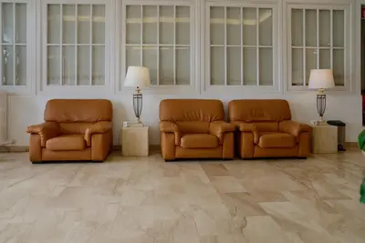 two chairs and a couch in a room at Hotel Miramar Badalona in Badalona