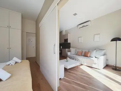 a living room with a white couch and a table at Stay U-nique Apartments Fontanella in Barcelona