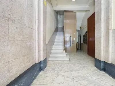 a hallway of a building with stairs and a stair case at Stay U-nique Apartments Fontanella in Barcelona