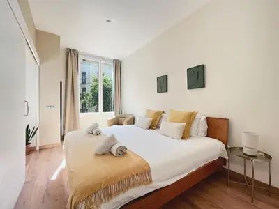 a bedroom with a large white bed with a window at Stay U-nique Apartments Fontanella in Barcelona